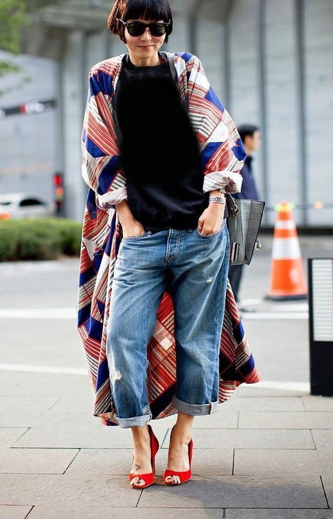 Street-style mood reference combining relaxed denim with expressive layered clothing